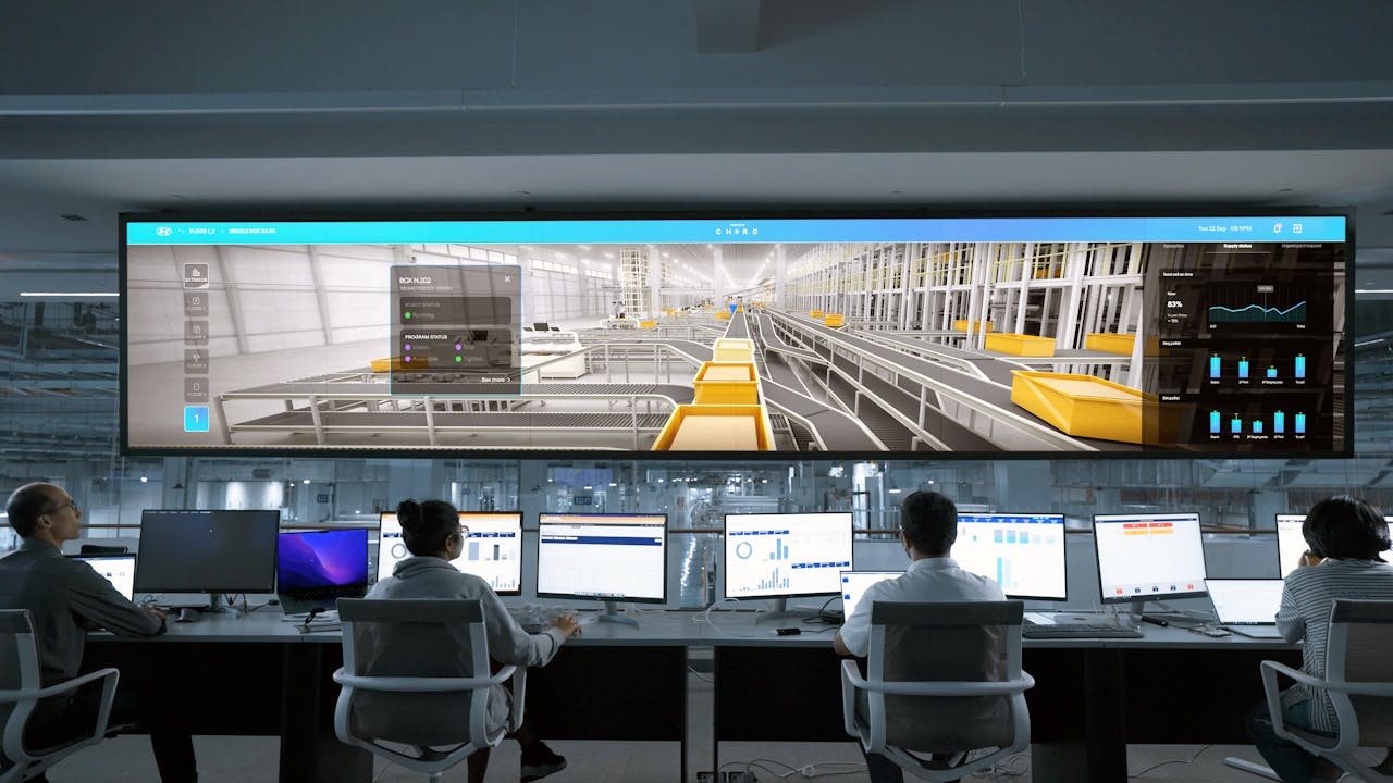 Services Modern control room with people monitoring large digital displays and computer systems.